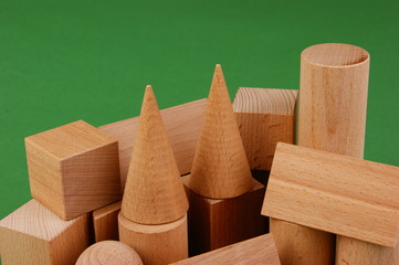 wooden geometric shapes on a green background