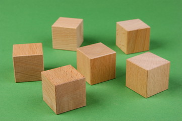 wooden geometric shapes on a green background