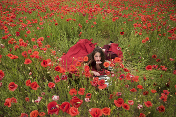 Woman writer in poppy flower field.