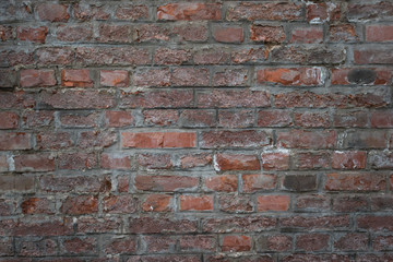 Old brick wall as background, texture or pattern. Dark red and orange brick wall. Poster or cover.