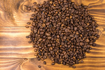 Roasted coffee beans on wooden background