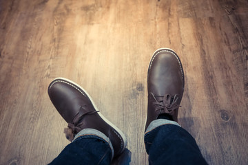 model showing new boots shoes on a wooden floor