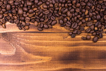 Roasted coffee beans on wooden background