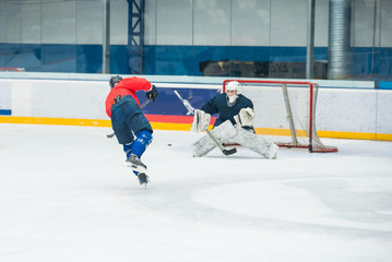 Hockey player and goalkeeper on ice, training sport photo