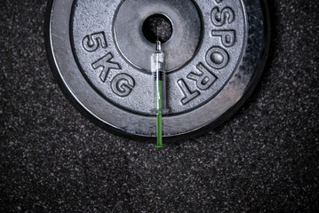 Doping in sport and steroid abuse concept with a dumbbell,