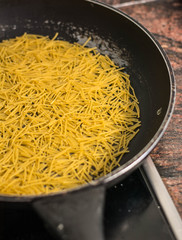 cooking a spanish fideua, a typical noodles casserole, the noodle paella, with seafood, making traditional Fideua from Spain.