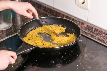 cooking a spanish fideua, a typical noodles casserole with seafood, making traditional Fideua from Spain, a typical noodle paella