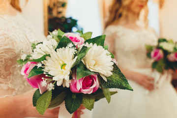 Beautiful bride in white wedding dress holding bouquet