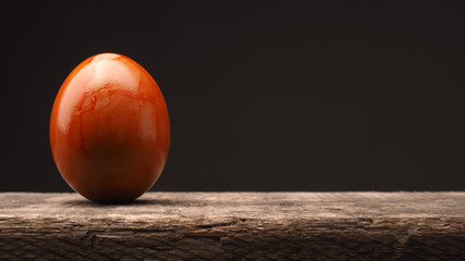 Colored Easter egg on wood