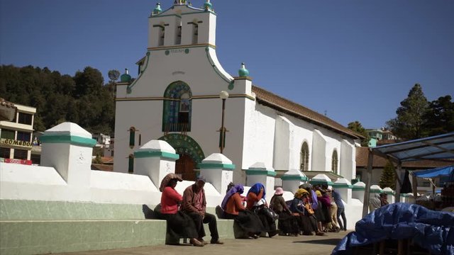 14 February 2017 Mexico, Chamula. people in tradition clothes sitting near San Juan Chamula Church in colonial town Chamula