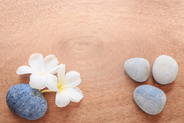 Frangipani or Plumeria  flower and stone zen spa on wooden plank