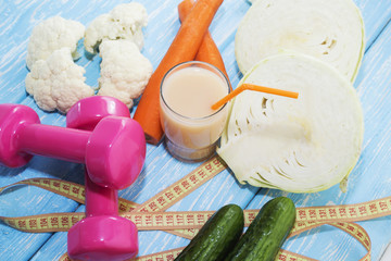 Fitness concept with dumbbells and healthy food.