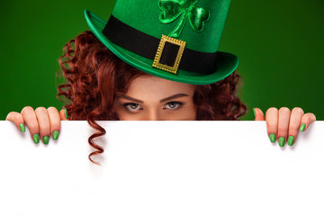 St patricks day. Young sexy ginger Oktober fest woman leprechaun, wearing a traditional Bavarian...