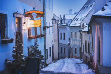 Beautiful winter city street, old houses, city lamp, in winter evening. Romantic Christmas evening.
