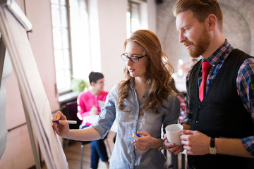 Young attractive architects discussing in modern office