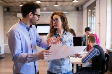 Young attractive architects discussing in modern office