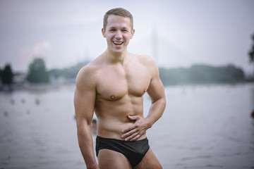 Young athletic caucasian man posing on the beach