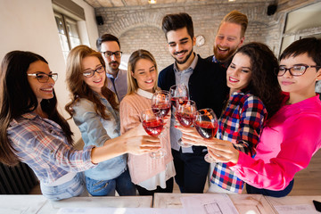 Group of successful architects celebrating in office