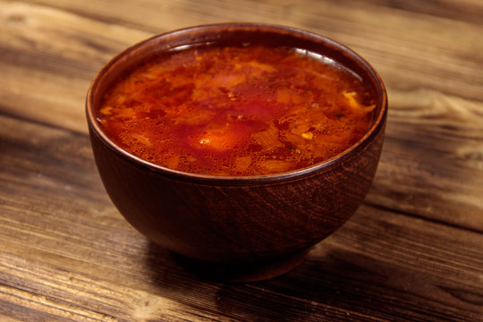 Ukrainian and Russian traditional beetroot soup - borscht on wooden table