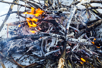 A bonfire on the snow in the winter.