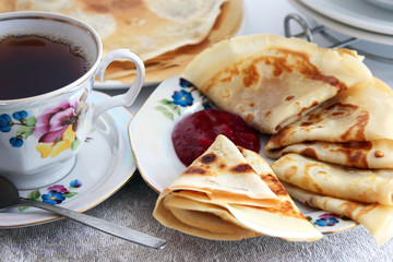 Tea with pancakes and jam..