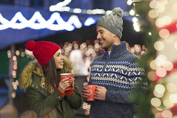 Young Couple Having Fun Outdoors At Christmas Time
