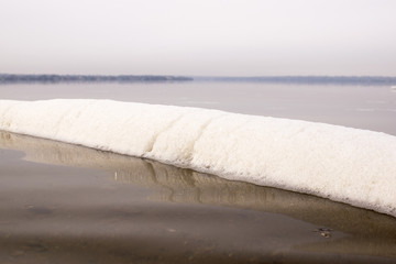 foam from the pipe on the water surface