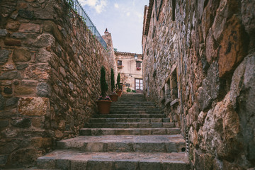 Fototapeta na wymiar Ancient streets and yards of Tossa De Mar city, Catalonia, Spain, Europe. Wanderlust travel concept.