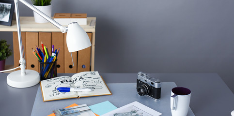 Designer table with him lying on the instruments and camera