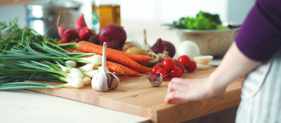 Young Woman Cooking in the kitchen. Healthy Food
