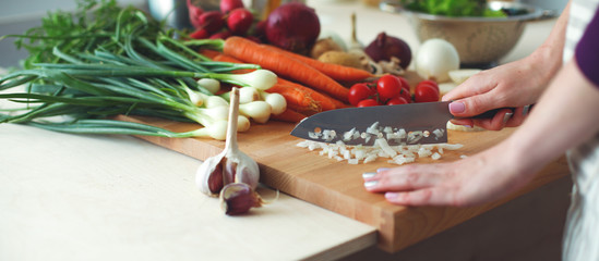 Young Woman Cooking in the kitchen. Healthy Food