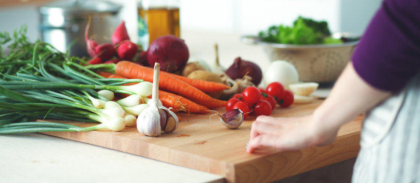 Young Woman Cooking In The Kitchen. Healthy Food