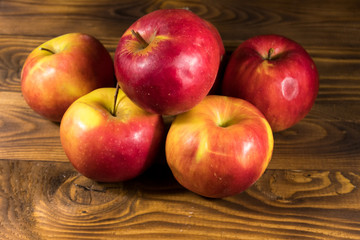 Red apples on wooden table