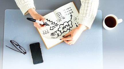 Young female designer using graphics tablet while working with computer