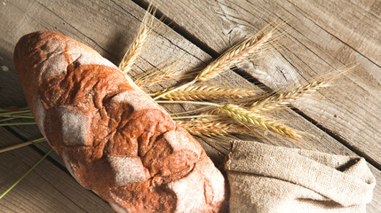 Freshly baked traditional bread on wooden table