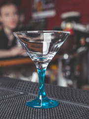 Empty glass for martini on a bar counter