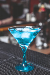 Cocktail in a glass with ice on a bar counter