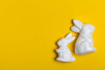 Easter bunny rabbits on a bright yellow background