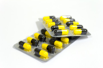 yellow and black capsule medicine.
