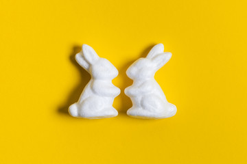 Easter bunny rabbits on a bright yellow background
