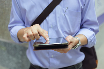 Businessman working with smartphone or taplet. Concept of modern technology, network connection.
