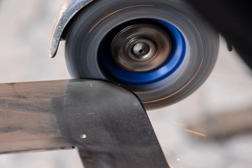 Cutting steel with angle grinder at car service