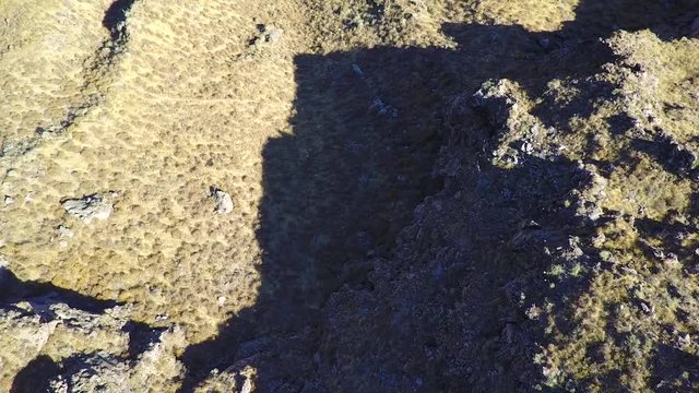 Bird's eye drone aerial flying over the edge of the Colca Canyon valley in Peru