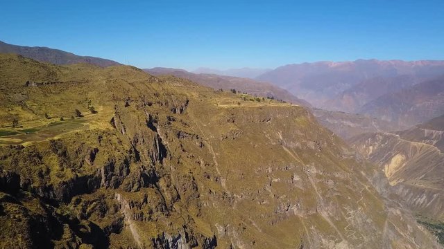 Fast aerial panorama across the cliff face of the Colca Canyon in Peru