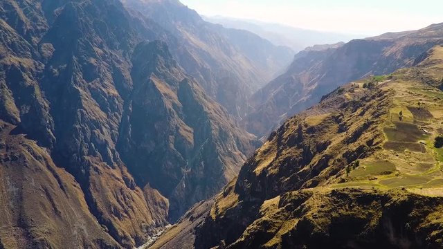 Drone aerial flying sideways over the massive Colca Canyon valley in Peru