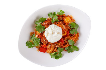 Stewed vegetables with meat and poached egg on a white background.