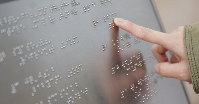 Blind reading on Braille at outdoor directory