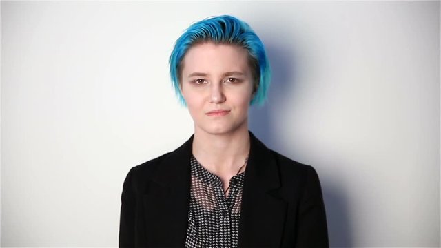 modern youth. calm portrait of a smiling girl of unusual appearance with blue hair.