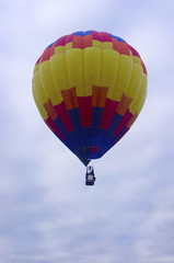 Colorful hot air balloon rising into air
