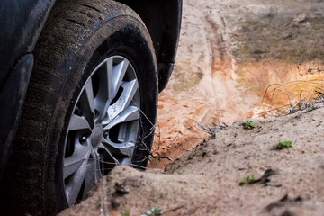 Fototapeta na wymiar SUV tire on the background of the sandy road